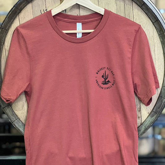 Unisex rust red shirt with the Whiskey Del Bac logo on the front. The back says "mesquited not peated".